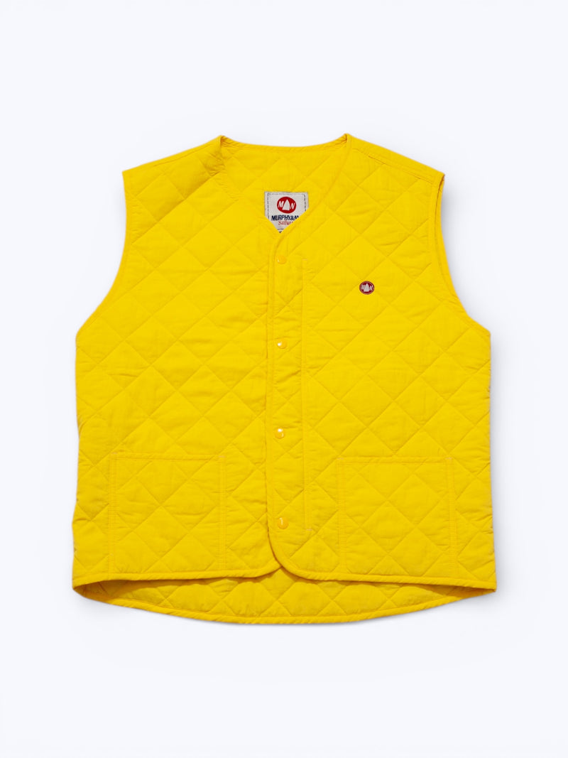 Yellow quilted vest on a white background