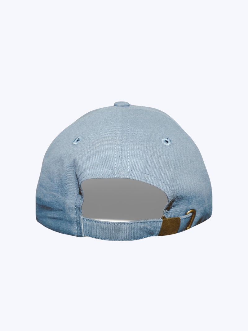 Blue denim cap with a brown patch on a white background