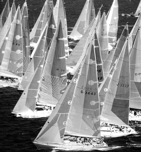 Black and white photo of sailboats with numbered sails in Porto Cervo during The Sardinia Cup