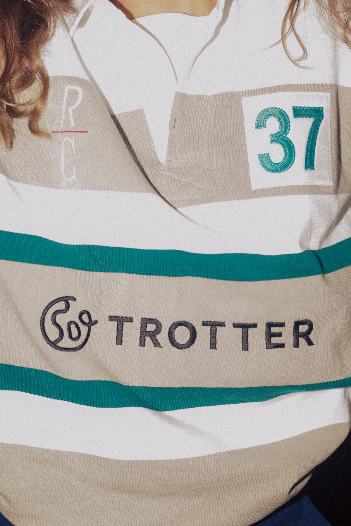 Close-up of a rugby shirt with Trotter branding and number 37 on a person wearing it.