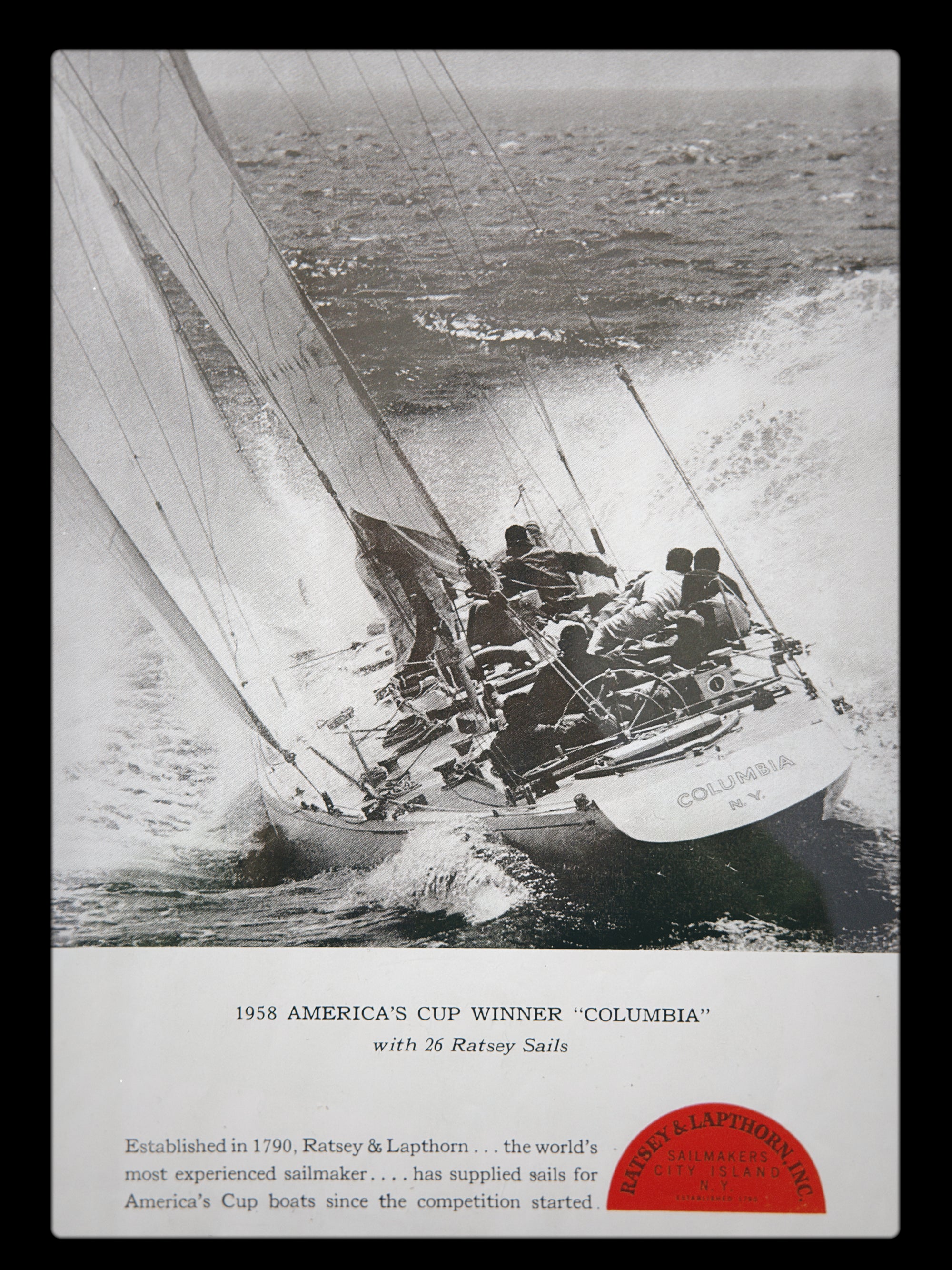 Vintage black and white photograph of a sailboat with text about the 1938 America's Cup winner 'Columbia'.