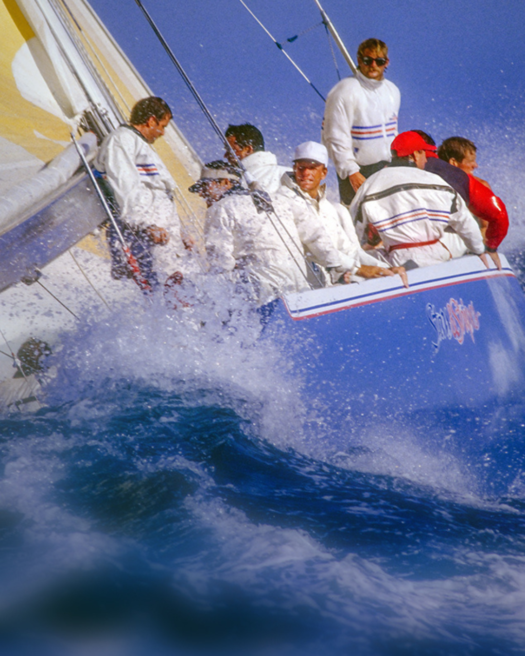 Sailboat with crew members on a sunny day